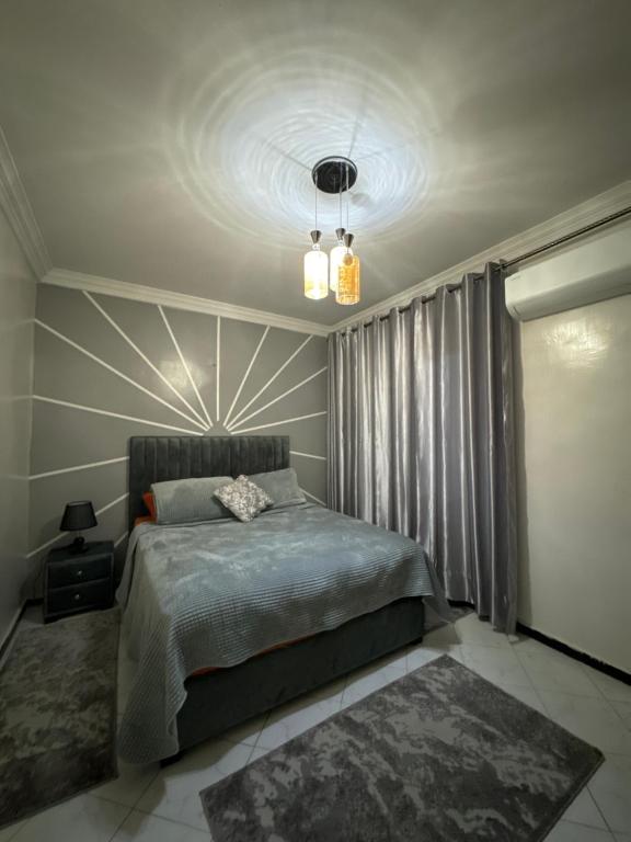 a bedroom with a bed and a large window at Tranquility In the Center of Fez in Fez