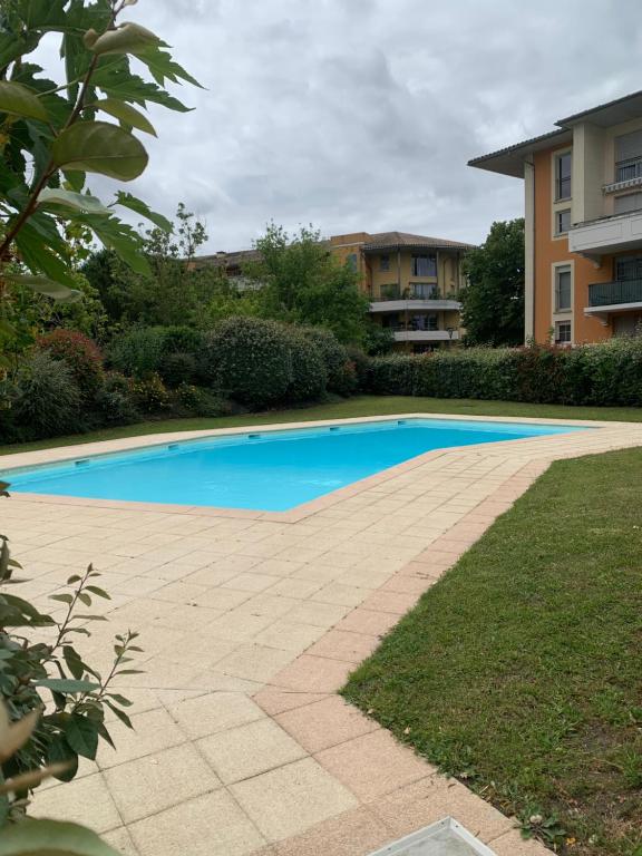 - une piscine dans la cour d'un bâtiment dans l'établissement City Rose T2, Climatisation,parking privé, piscine, wifi , tout confort, à Toulouse