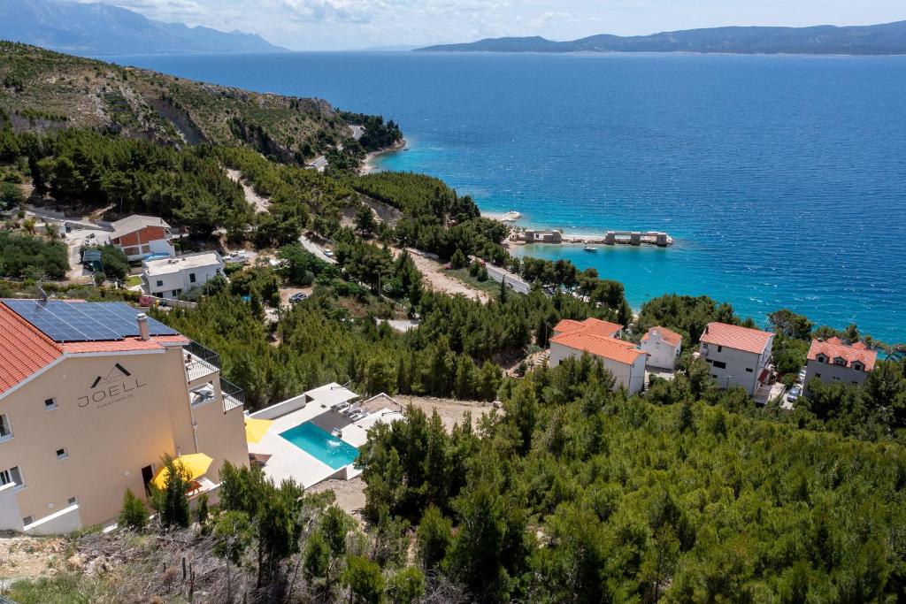 an aerial view of a village on a hill next to the water at JOELL Apartments in Lokva Rogoznica
