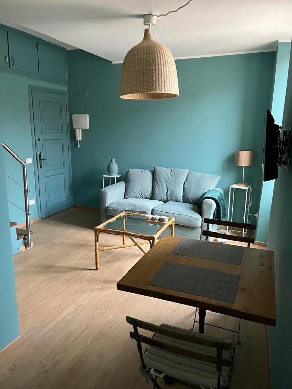 a living room with a couch and a table at La terrazzina OLTRE HOME HOLIDAYS in Sanremo