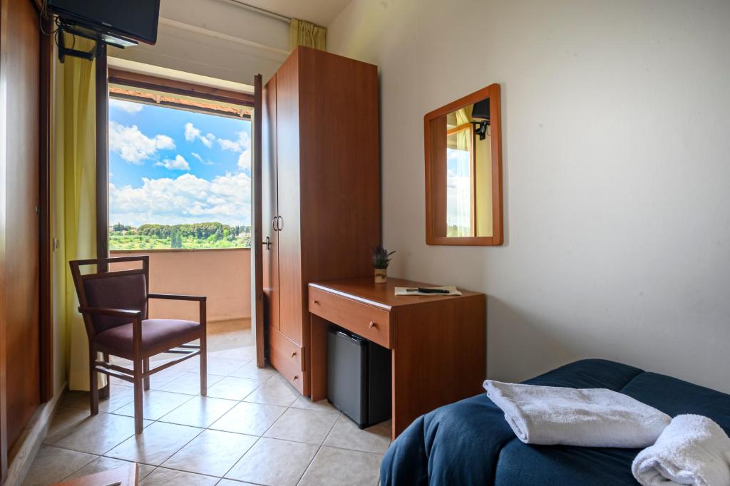 Postel nebo postele na pokoji v ubytování Hotel Vico Alto Siena