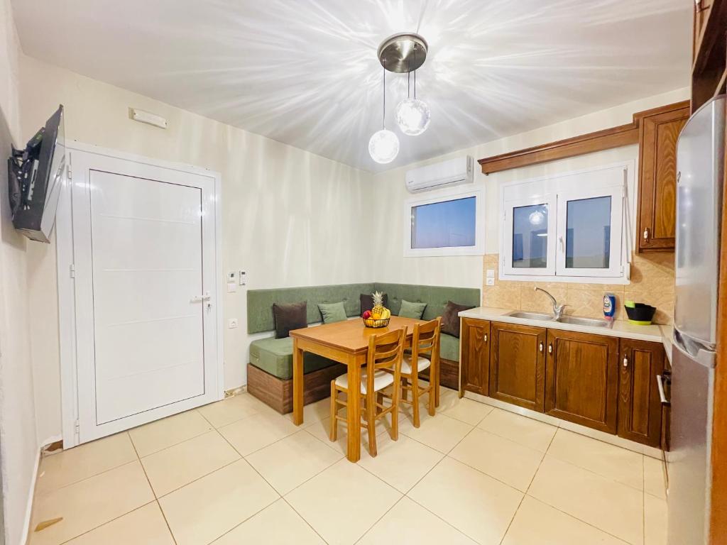 a kitchen and living room with a table and a kitchen and a dining room at Lafo Rooms in Elafonisi