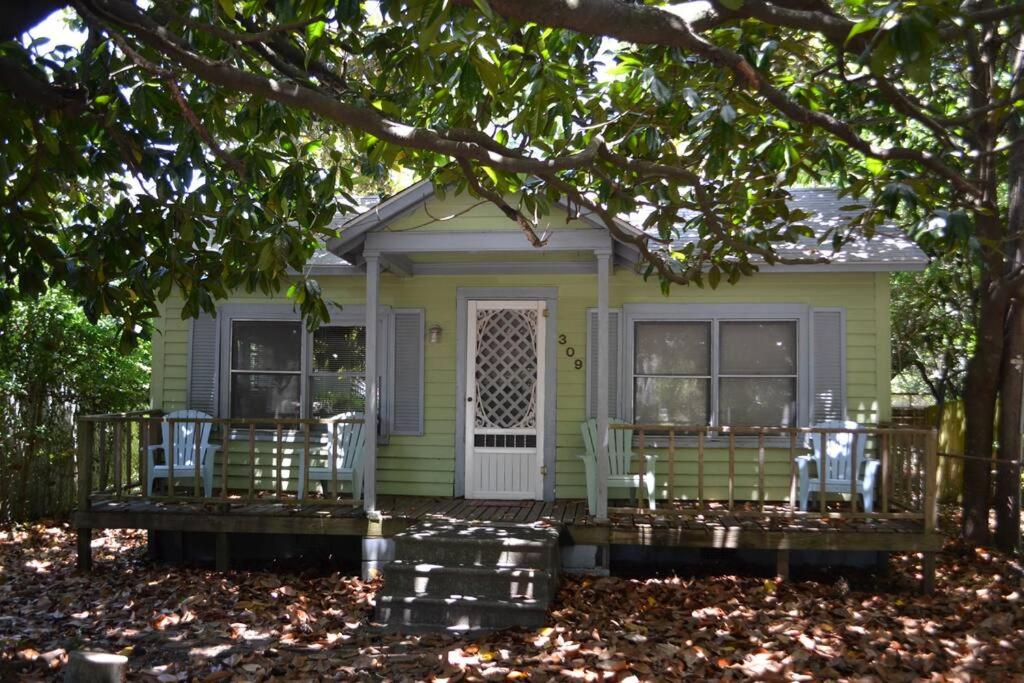 a small green house with chairs on the porch at Beaufort Harbour Suites East Lodge in Beaufort