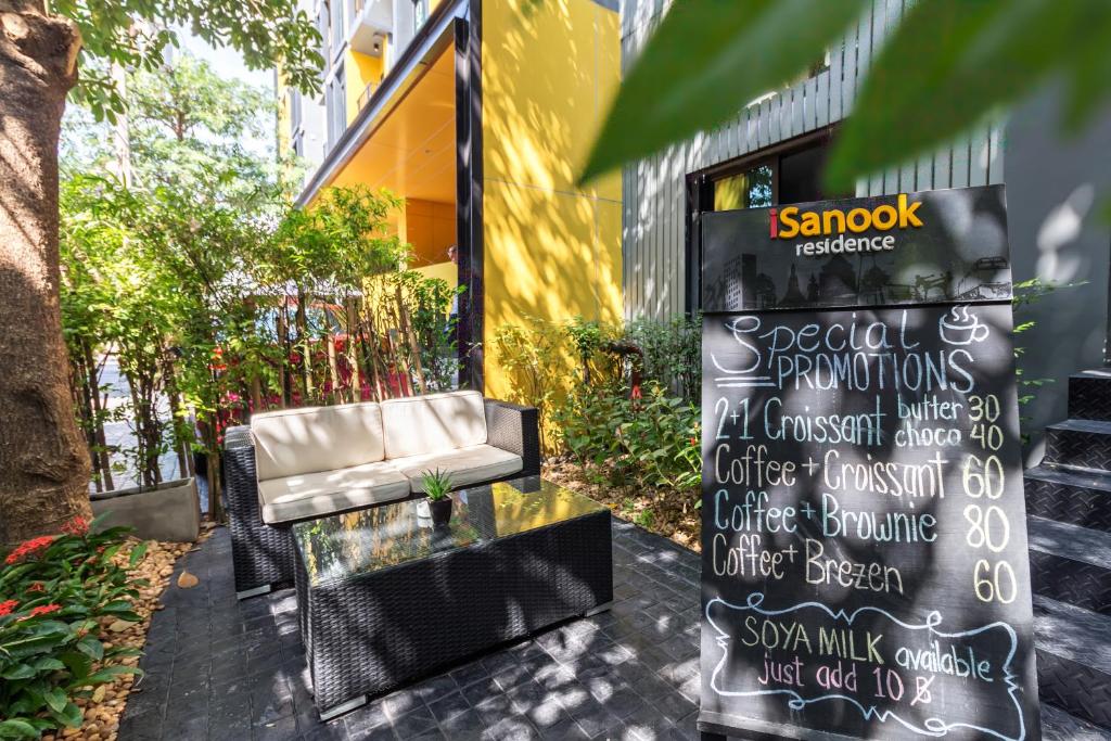 a chair and a sign outside of a building at iSanook Hostel in Bangkok
