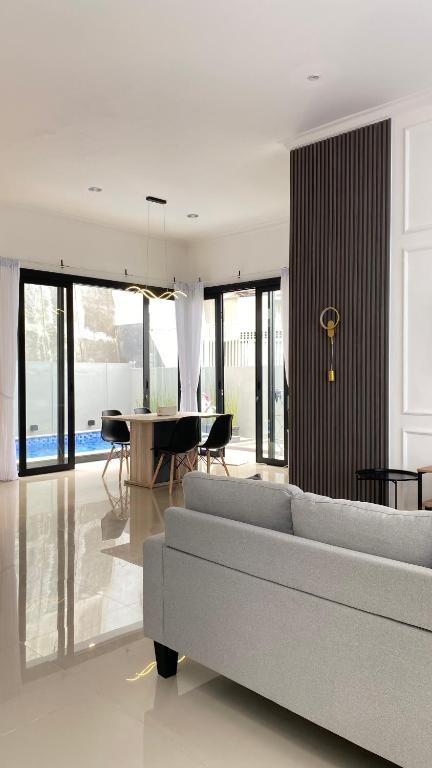 a living room with a couch and a table at Eben Haezer Villas in Karangploso