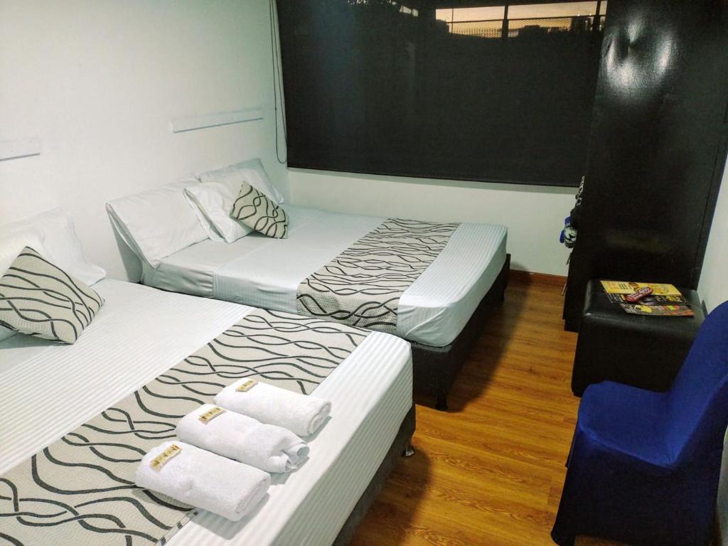 Postel nebo postele na pokoji v ubytování Hotel Bogotá la embajada