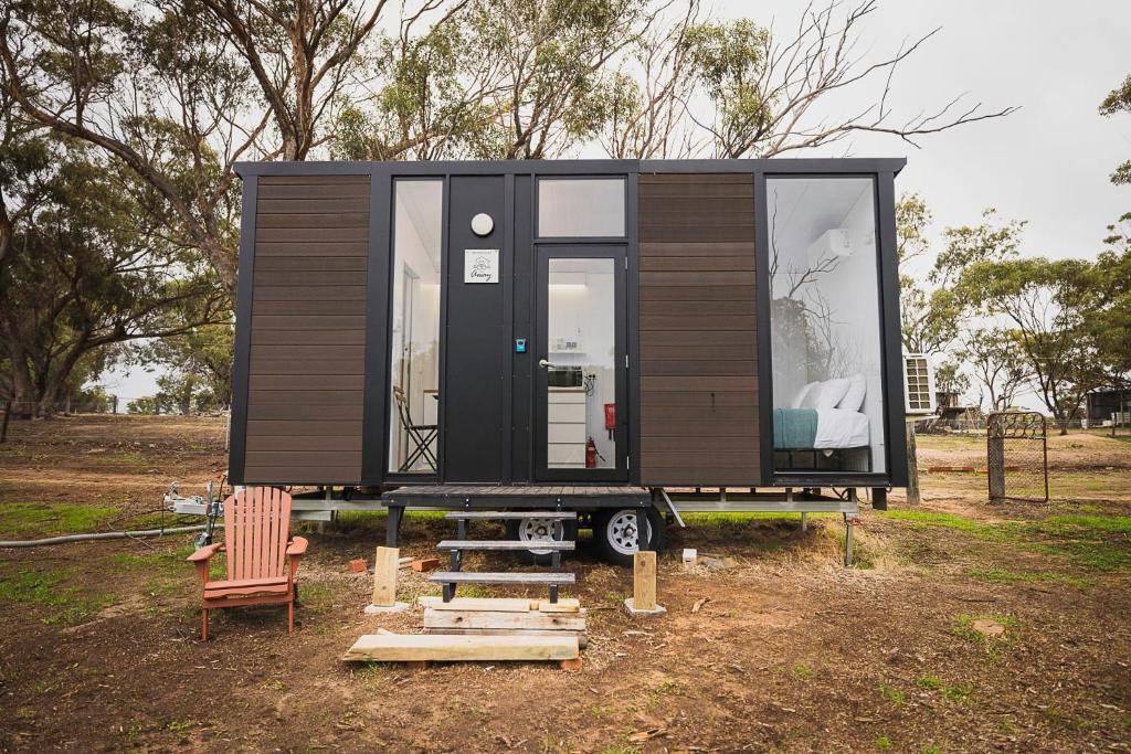 a tiny house on a trailer in a field at McCabe Farm Cabin by Tiny Away in Brookton