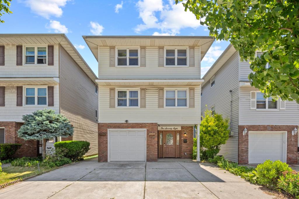 a house with a driveway in front of it at Cozy 3BR, Near NYC, Cruise Port,Statue of Liberty, Free Driveway Parking in Bayonne