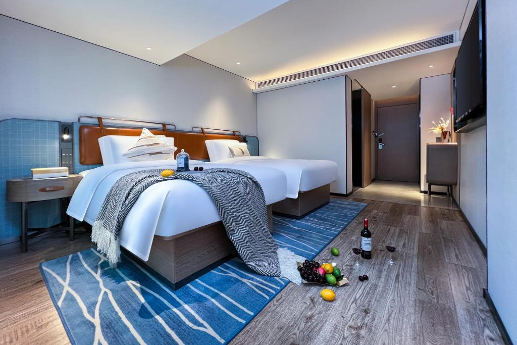 Postel nebo postele na pokoji v ubytování Echarm Hotel Guangzhou Dongpu Financial City Pazhou Convention Center - Free shuttle bus for Canton Fair