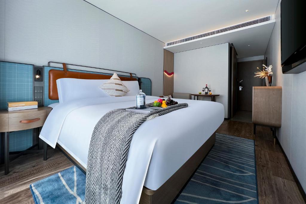Postel nebo postele na pokoji v ubytování Echarm Hotel Guangzhou Dongpu Financial City Pazhou Convention Center - Free shuttle bus for Canton Fair