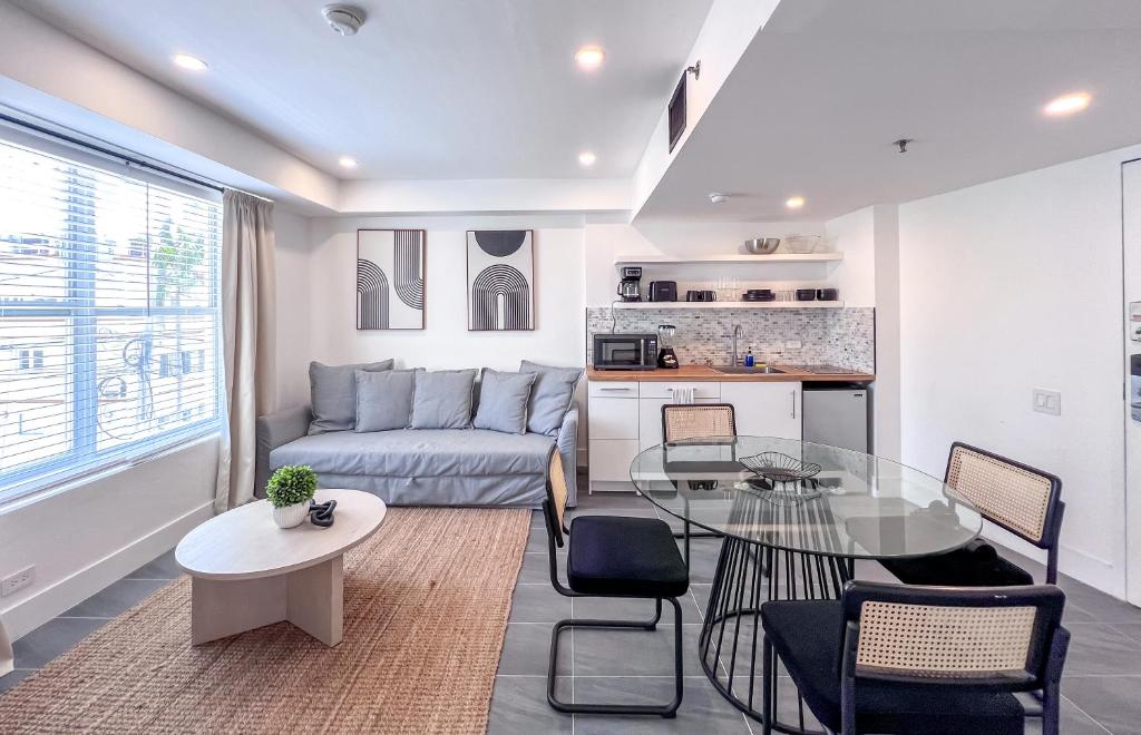 a living room with a couch and a glass table at Shaomi South Beach in Miami Beach