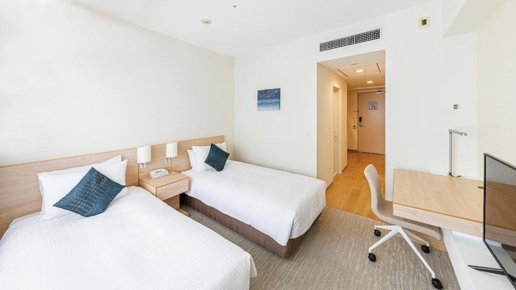 Postel nebo postele na pokoji v ubytování Fraser Residence Nankai Osaka