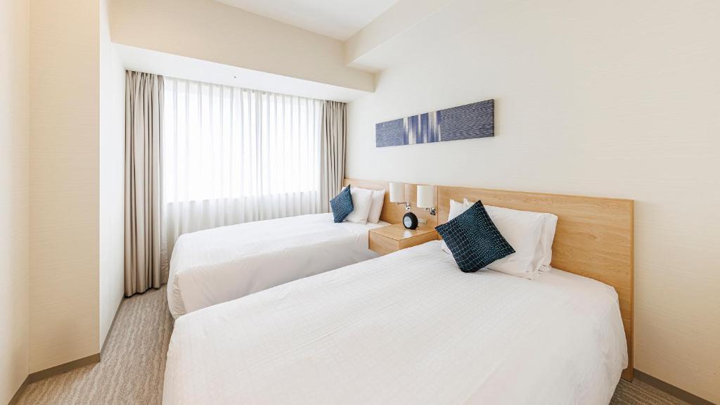 Postel nebo postele na pokoji v ubytování Fraser Residence Nankai Osaka