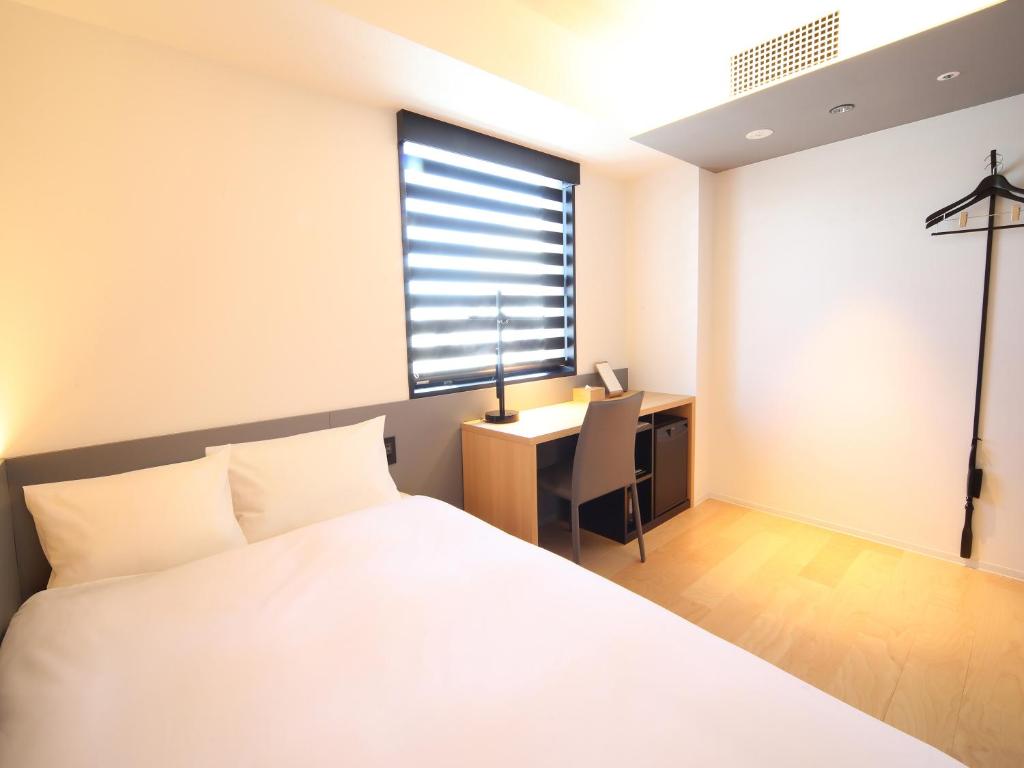Postel nebo postele na pokoji v ubytování hotel androoms Nagoya Sakae