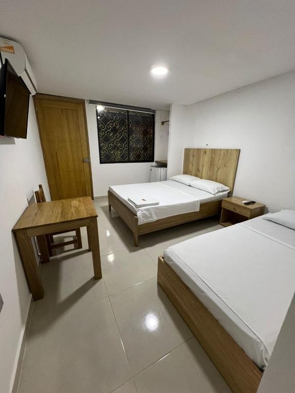 Postel nebo postele na pokoji v ubytování ApartaHotel Los Naranjos