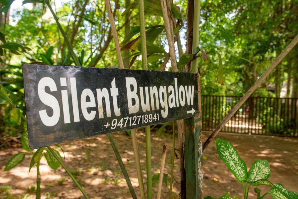 a sign for a short bunatown in a park at Silent Bungalow in Udawalawe