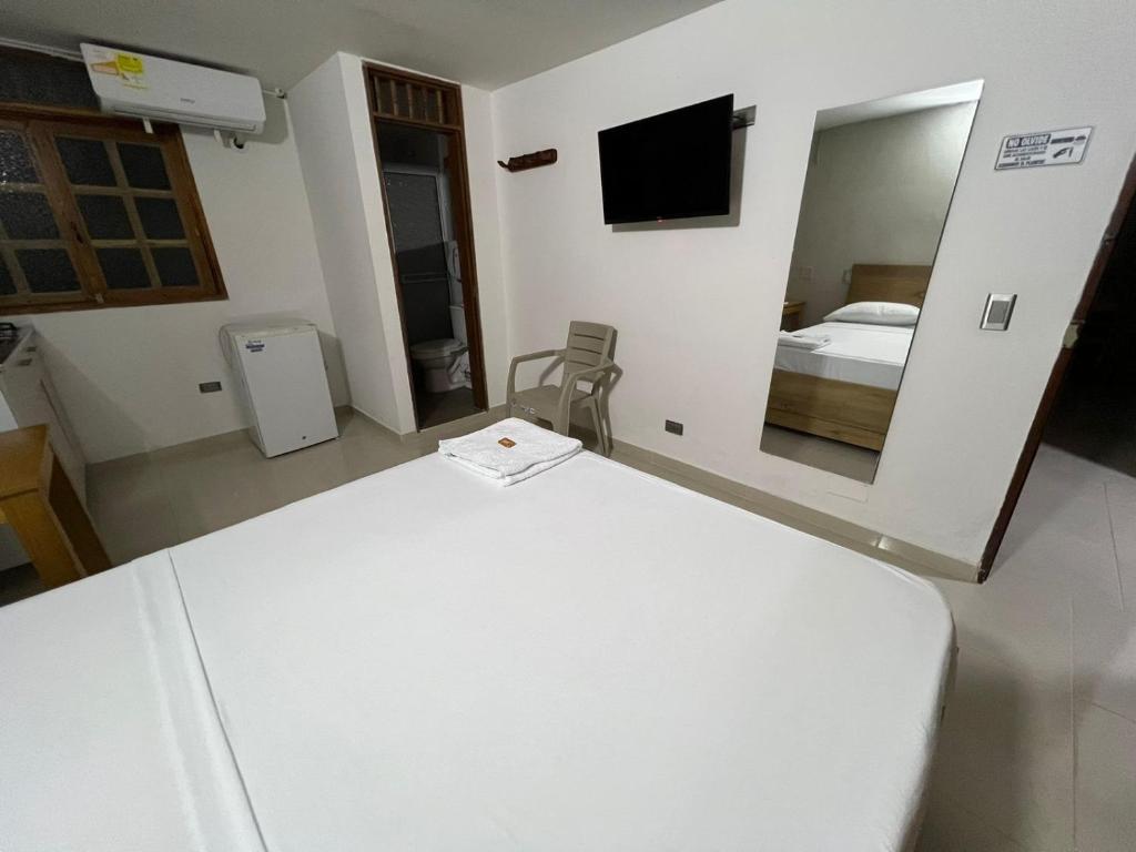 Postel nebo postele na pokoji v ubytování ApartaHotel Los Naranjos