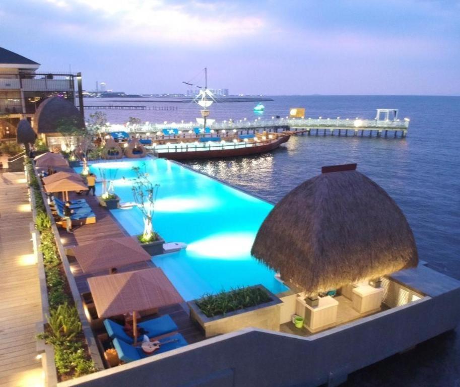 a swimming pool with a view of the ocean at Putri Duyung Ancol in Jakarta