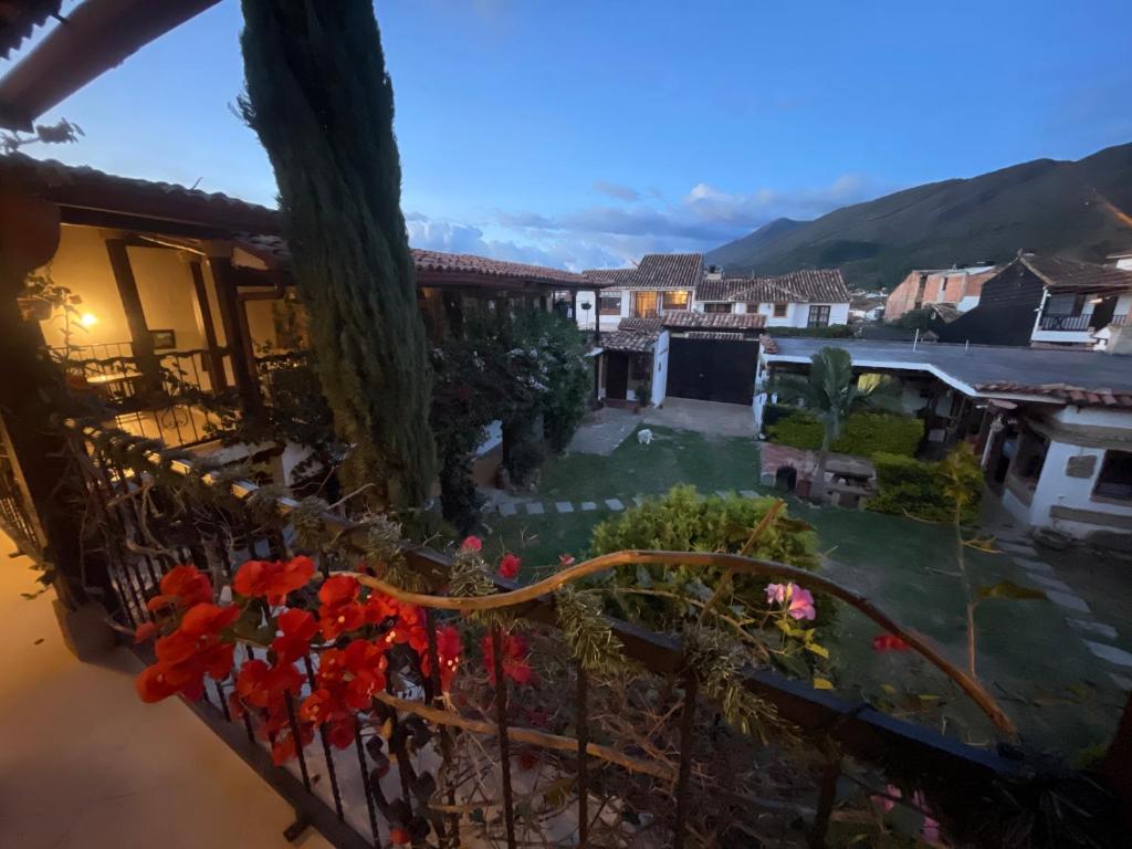 a view from the balcony of a house with red flowers at Casa Boyero de Berna Campestre in Villa de Leyva