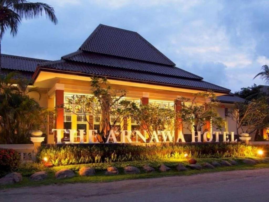 a hotel with a sign in front of it at The Arnawa Hotel in Pangandaran