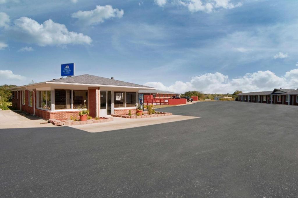 a parking lot in front of a building at Americas Best Value Inn & Suites Macon at Sunset Dr in Macon