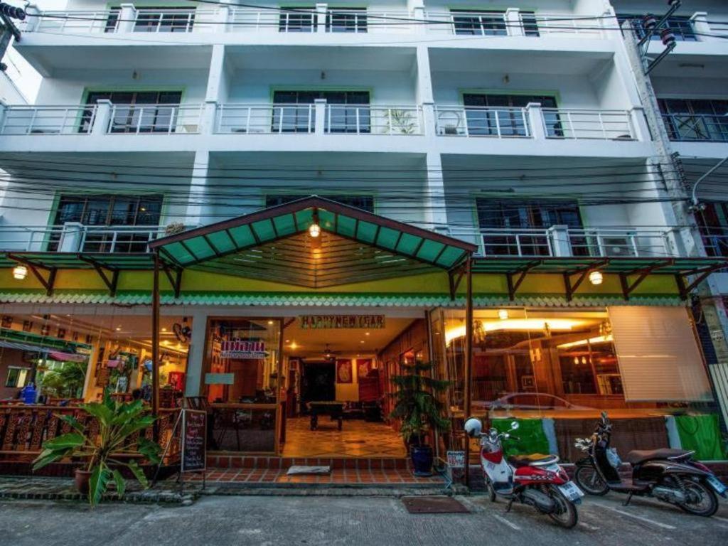 a building with motorcycles parked in front of it at Triple Rund Place Hotel in Patong Beach