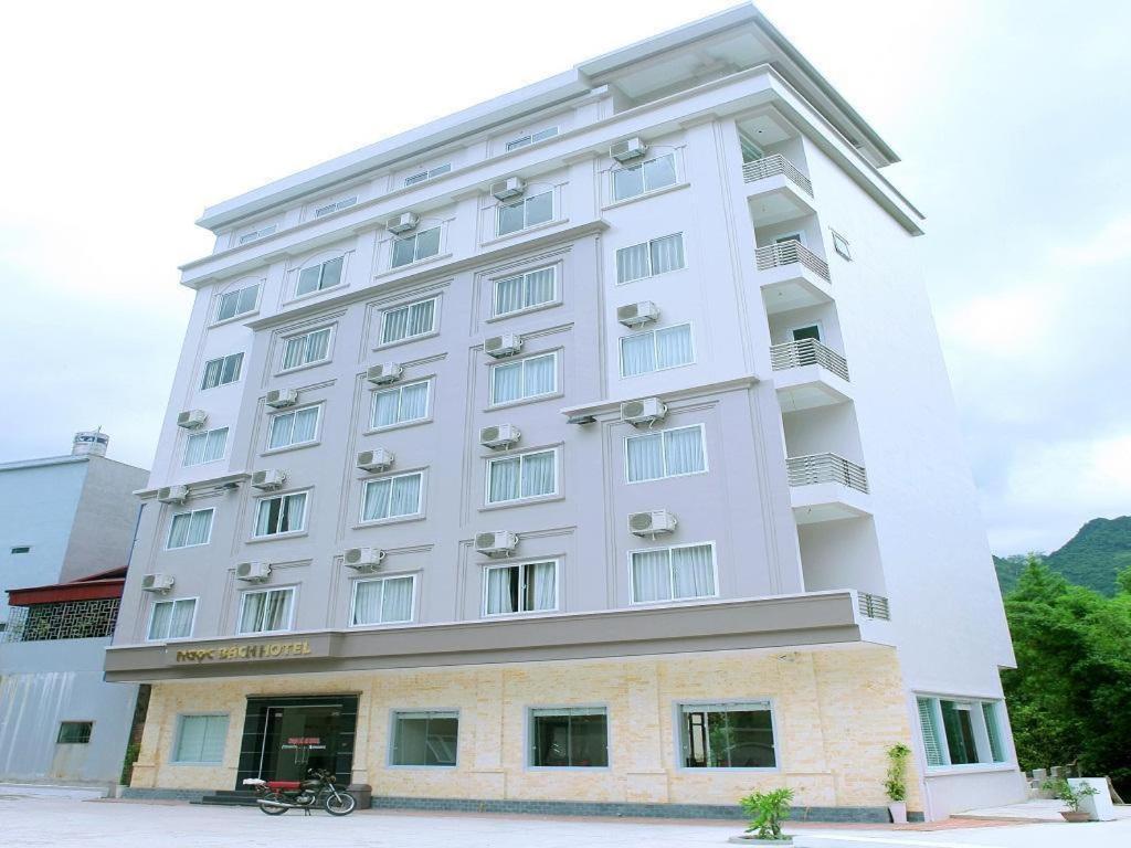 a large white building with a sign on it at Ngoc Bach Hotel in Mai Chau
