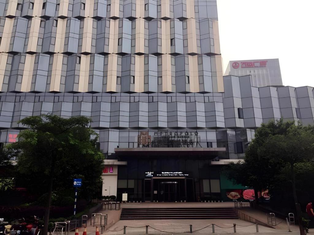 a large building with a staircase in front of it at Jinjiang Metropolo Fuzhou Cangshan in Fuzhou