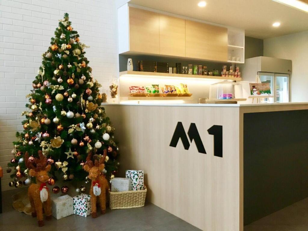 a christmas tree in a kitchen next to a counter at M-one Residence in Ban Kohong