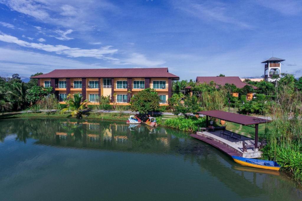 a building with a river in front of a building at Tamali Hotel in Ban Yuan Lae
