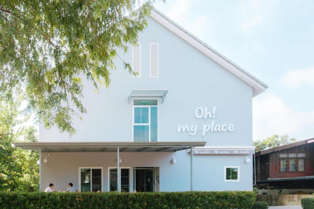 a white building with the words on my place on it at Oh My Place in Chiang Rai
