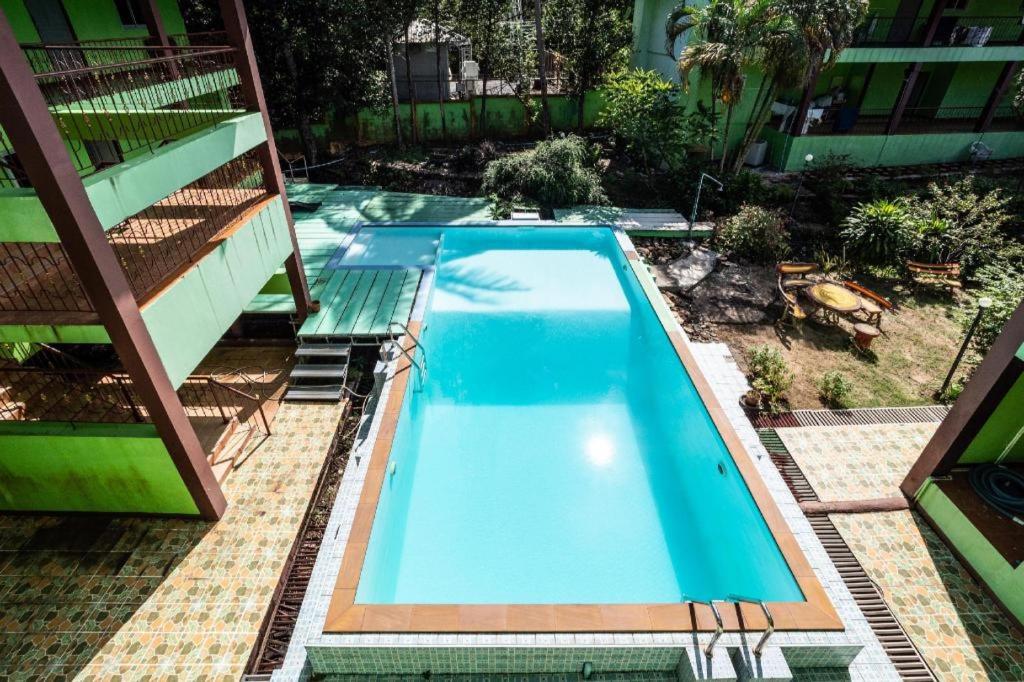 a large blue swimming pool next to a building at Alysia Spring Resort in Ko Chang