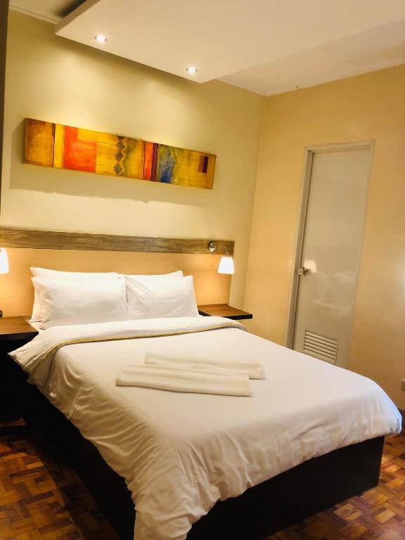 Postel nebo postele na pokoji v ubytování Baguio Holiday Villas