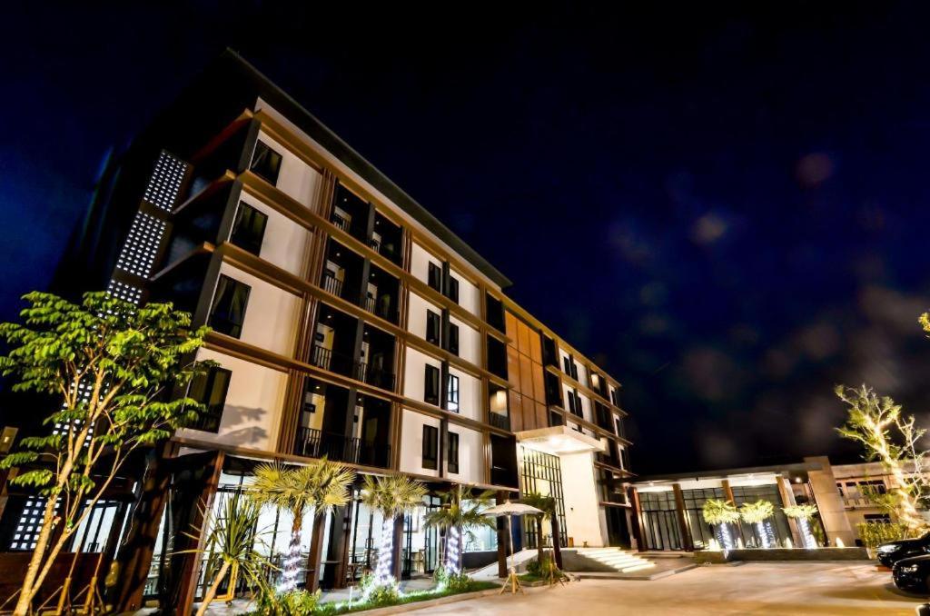 a large building with trees in front of it at Boondara Boutique Hotel in Nakhon Phanom