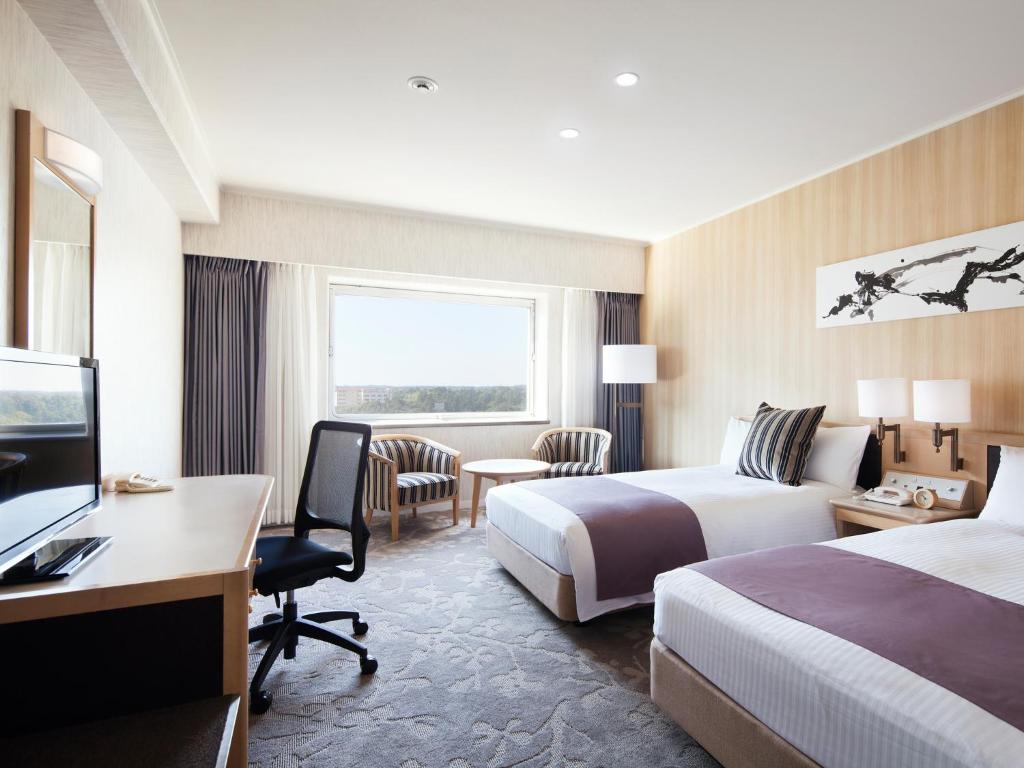 Postel nebo postele na pokoji v ubytování Hotel Nikko Narita