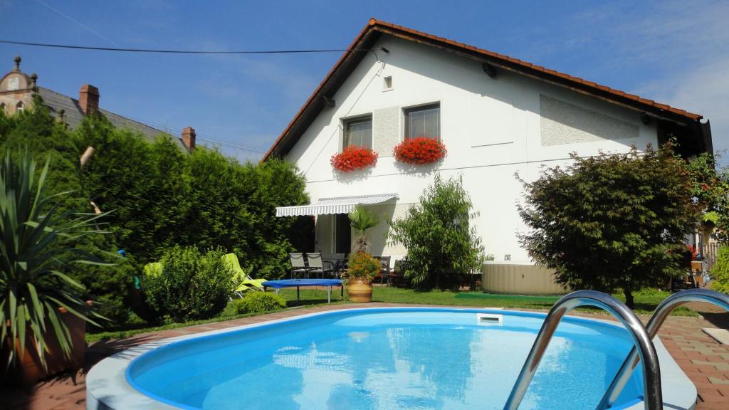 a villa with a swimming pool in front of a house at Holiday house Morávkovi in Horní Branná