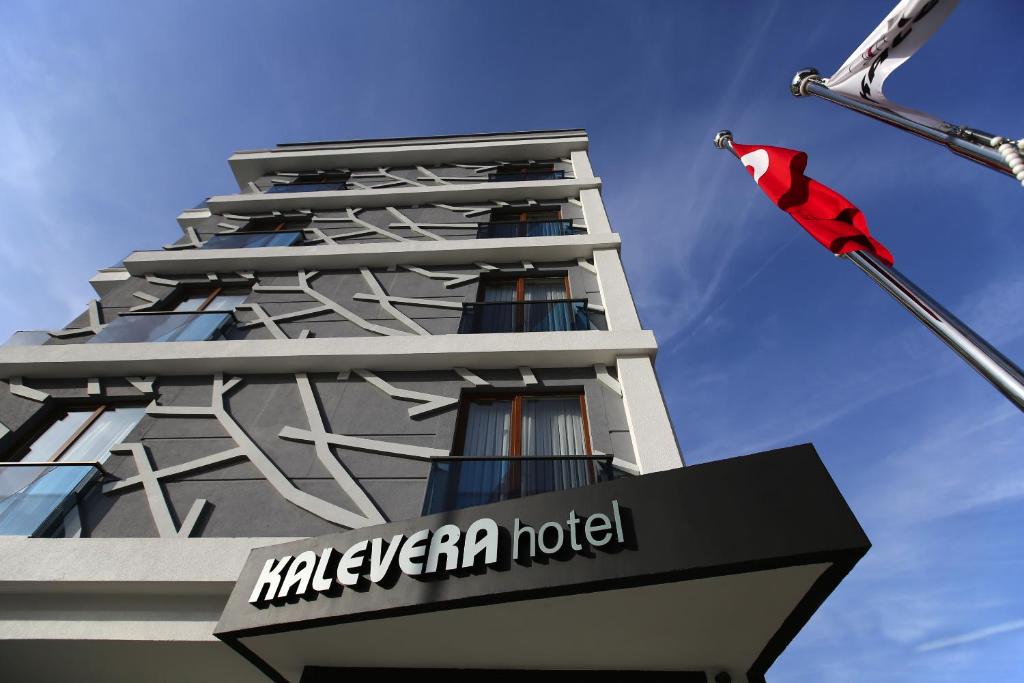 a hotel with a flag on the side of a building at Kalevera Hotel in Edirne