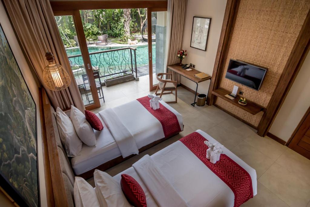 Postel nebo postele na pokoji v ubytování Anumana Ubud Hotel