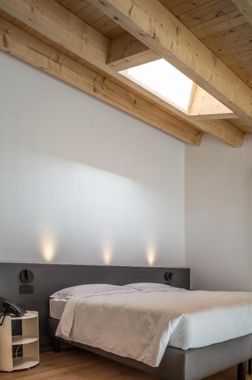 Postel nebo postele na pokoji v ubytování Hotel Acquamatta