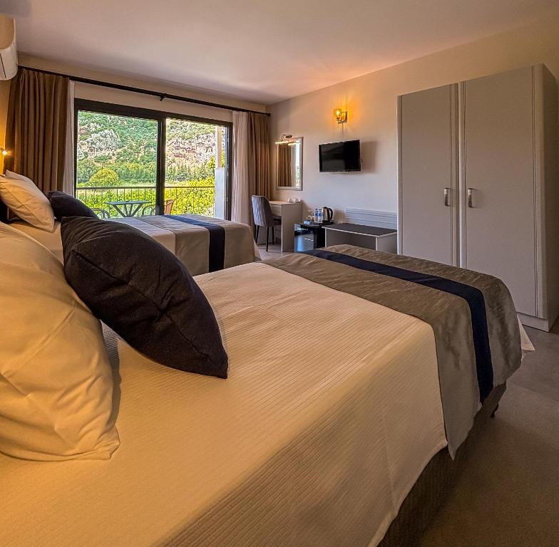 Postel nebo postele na pokoji v ubytování Aktaş Butik Hotel