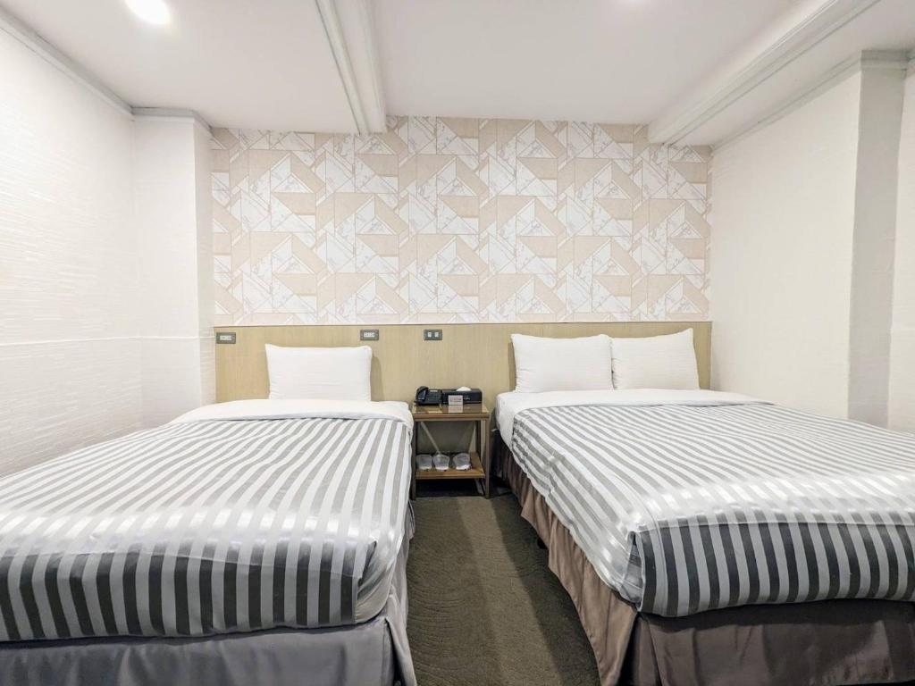 Postel nebo postele na pokoji v ubytování Ximen Hotel