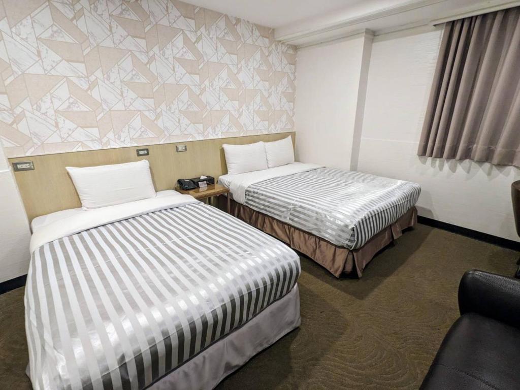 Postel nebo postele na pokoji v ubytování Ximen Hotel