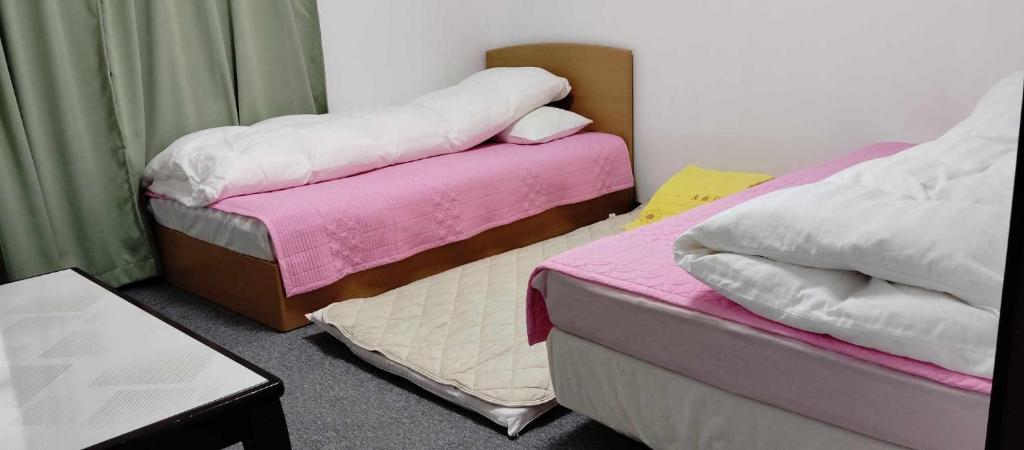 Postel nebo postele na pokoji v ubytování Oyama Guesthouse Kyoto