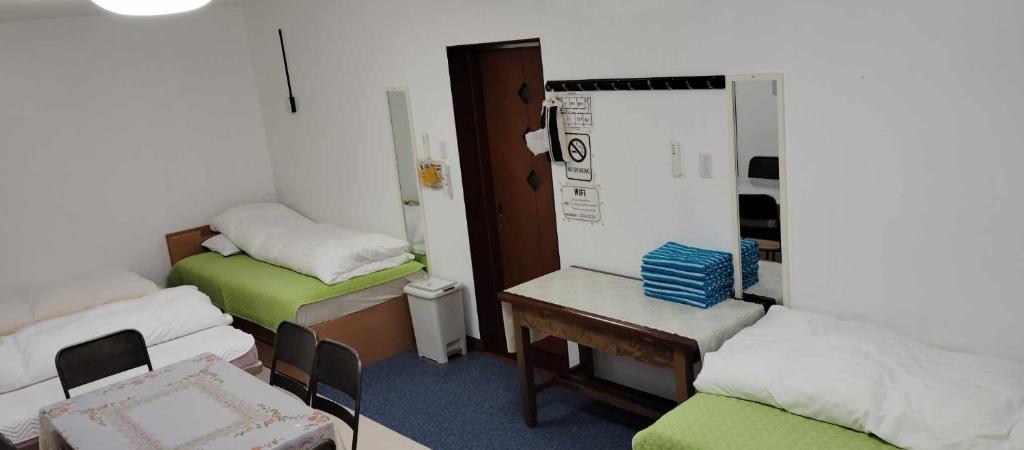 Postel nebo postele na pokoji v ubytování Oyama Guesthouse Kyoto