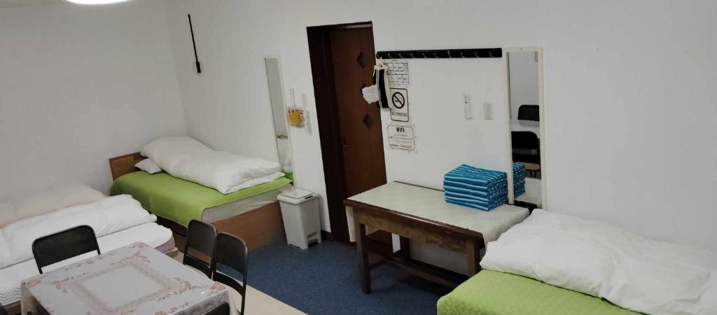 Postel nebo postele na pokoji v ubytování Oyama Guesthouse Kyoto