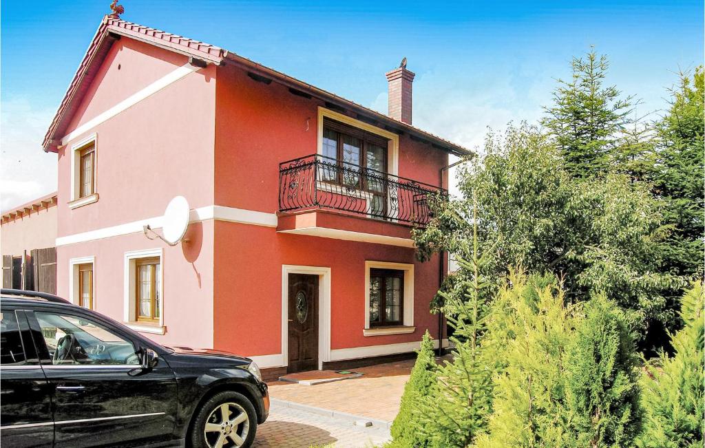 a house with a car parked in front of it at Awesome Home In Brzezno Szlacheckie in Brzeźno Szlacheckie