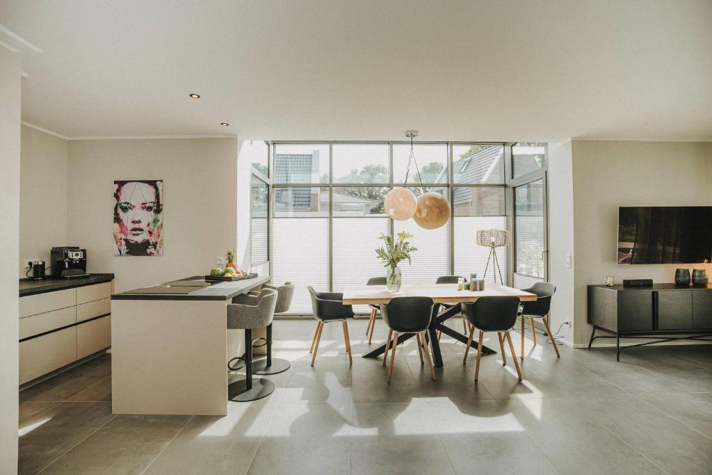 a kitchen and dining room with a table and chairs at Nordsee Park Haus Stella in Dangast