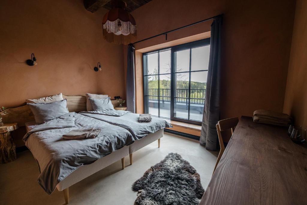 Postel nebo postele na pokoji v ubytování Ilmaveere Butiikhotell ja Restoran