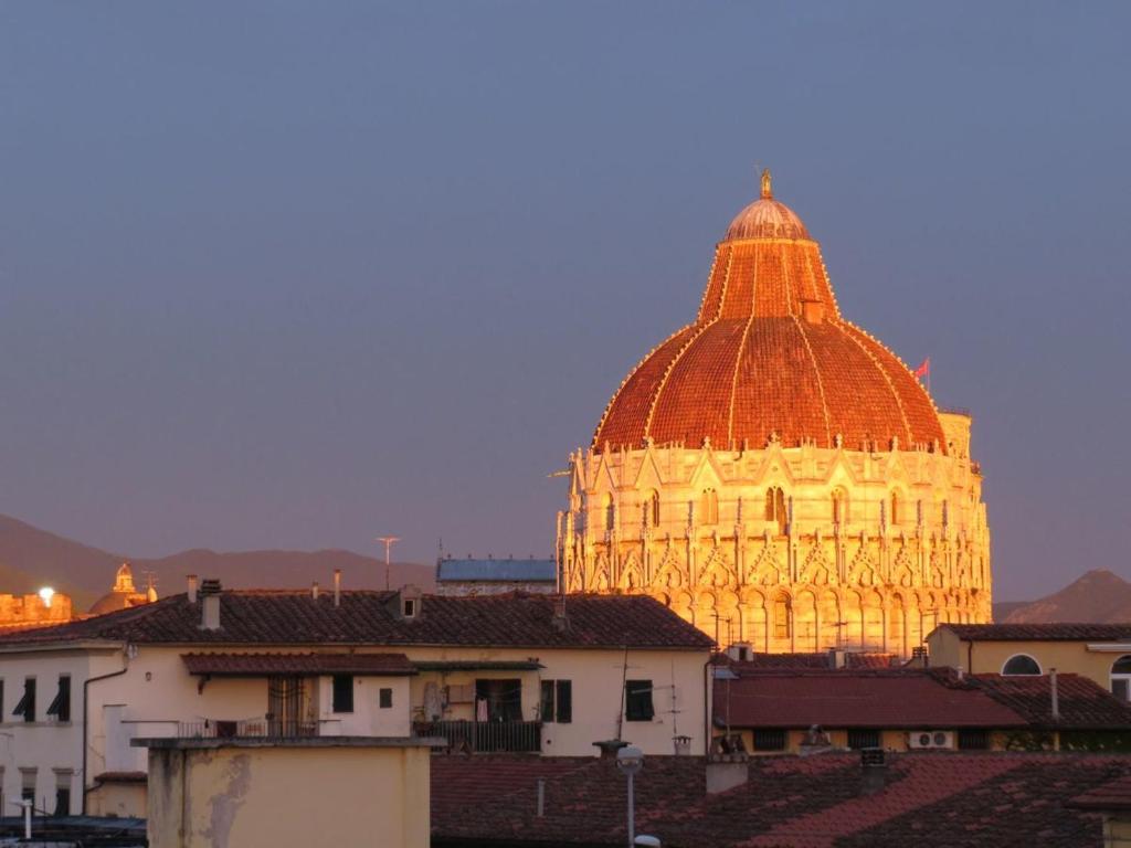 a large building with an orange dome in the background at Alla Torre Con Vista in Pisa