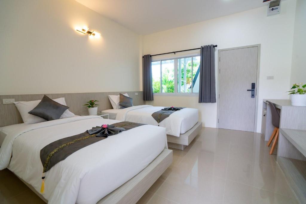 Postel nebo postele na pokoji v ubytování Puean Chang Resort Phuket